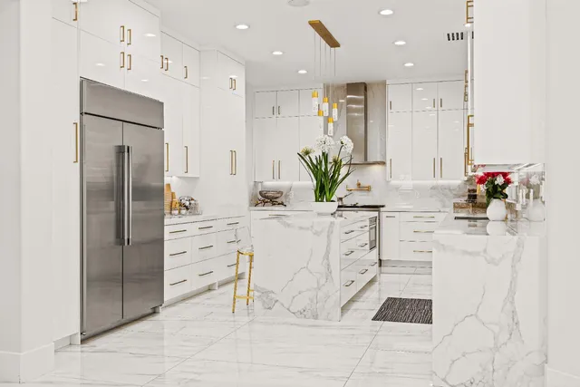a bathroom with a granite countertop sink a toilet and shower