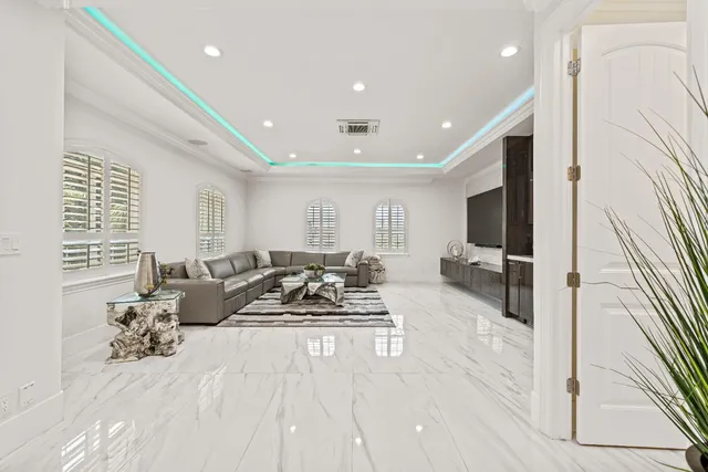 a spacious bedroom with a bed and a flat screen tv