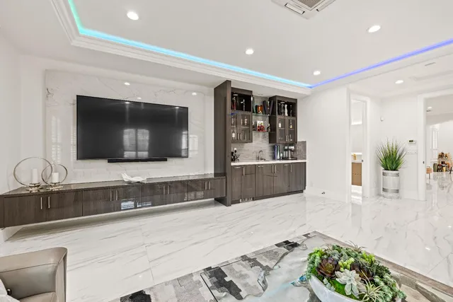 a view of a house with backyard sitting area and swimming pool