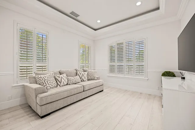 a view of a patio with chairs and potted plants