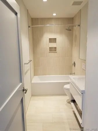 a bathroom with a bathtub and a toilet