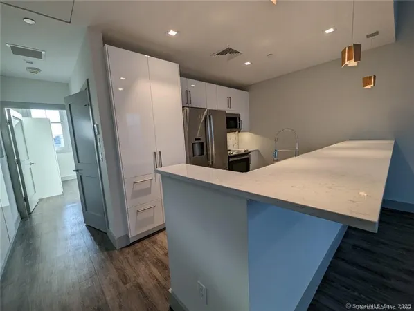 a kitchen with stainless steel appliances a refrigerator and a sink