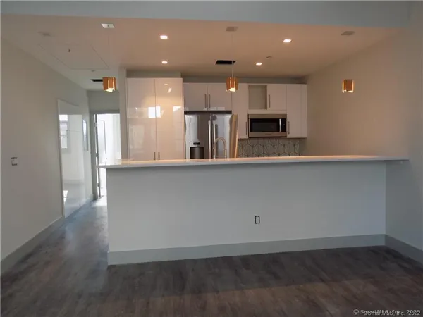 a kitchen with a refrigerator and a microwave
