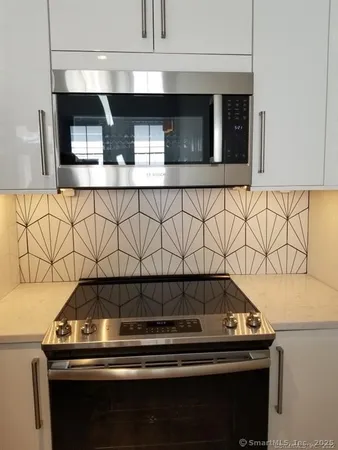 a refrigerator freezer sitting inside of a kitchen