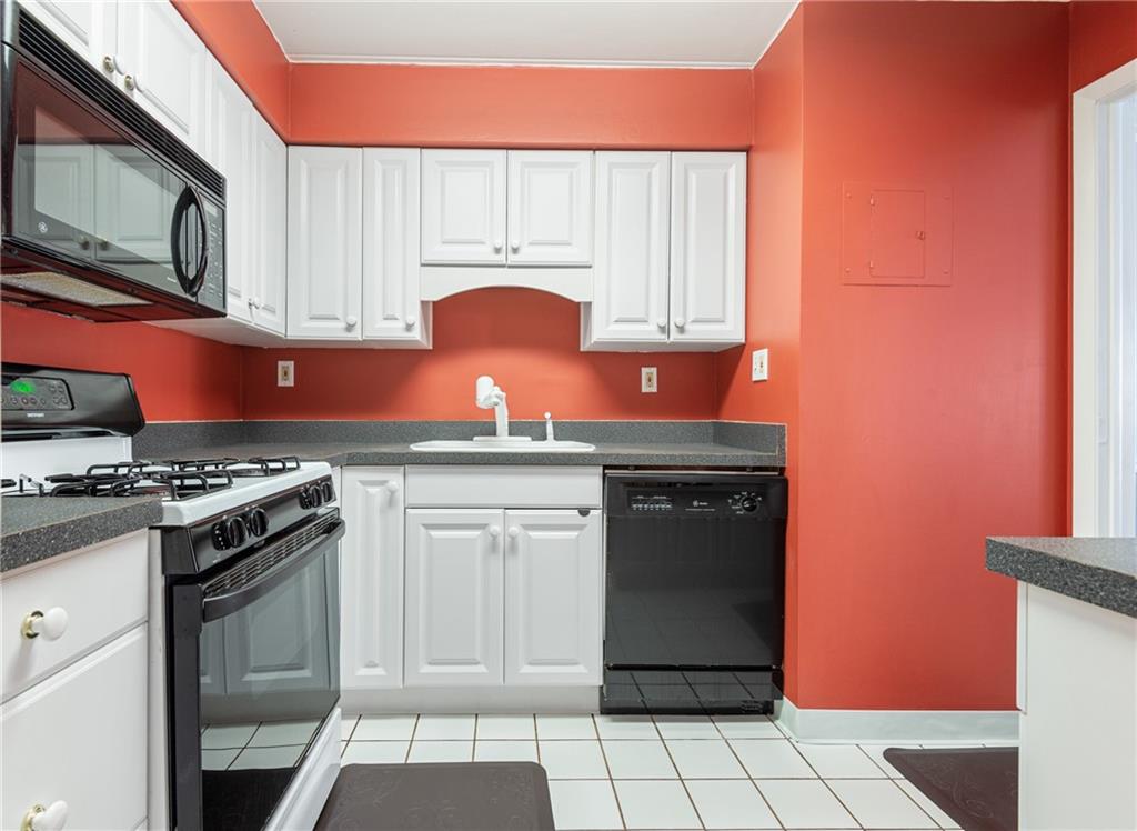 5 Bayard Road, Unit 308 Pittsburgh, PA 15213 - Photo 5 of 25 a kitchen with stainless steel appliances granite countertop a stove a sink and a microwave