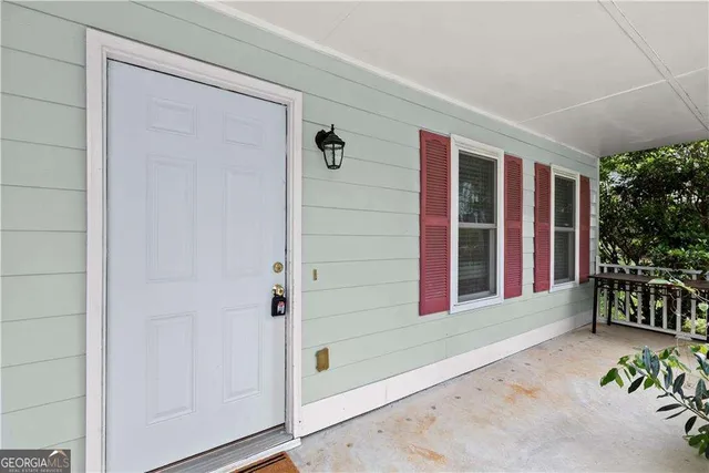a view of front door and porch with seating space