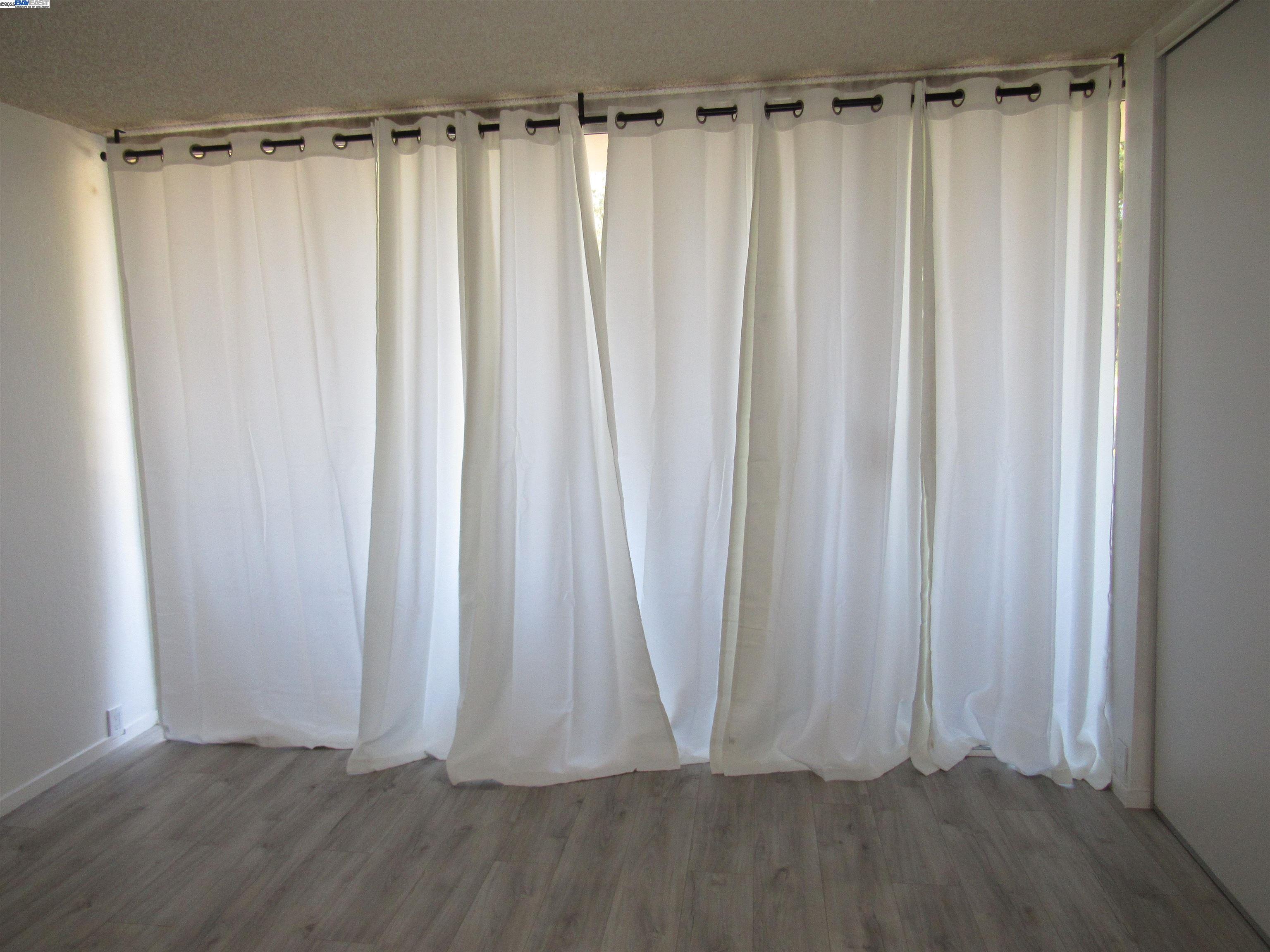 3909 Stevenson Boulevard, Unit 402 Fremont, CA 94538 - Photo 19 of 32 a view of a walk in closet with wooden floor