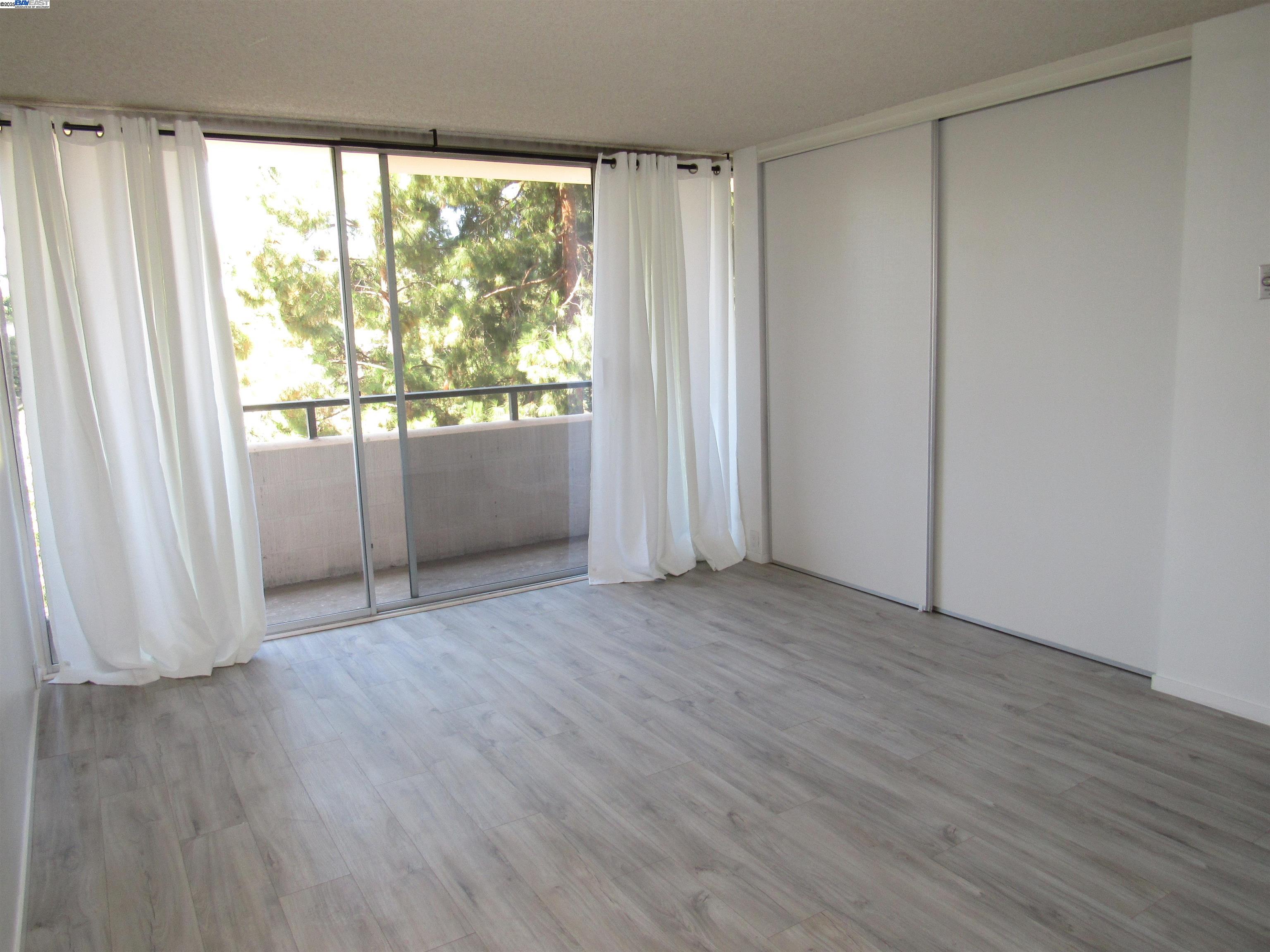 3909 Stevenson Boulevard, Unit 402 Fremont, CA 94538 - Photo 22 of 32 wooden floor in an empty room with a window