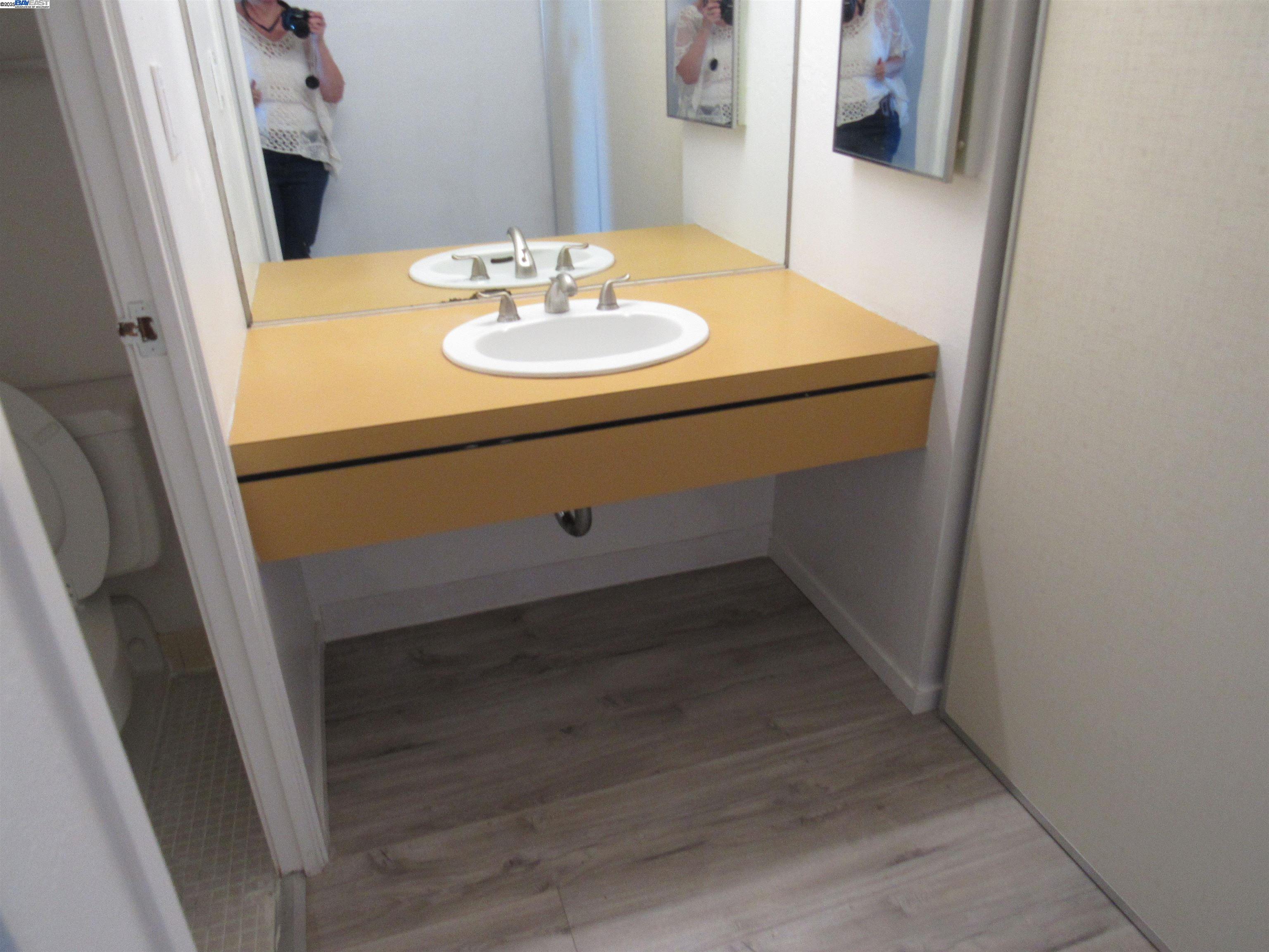 3909 Stevenson Boulevard, Unit 402 Fremont, CA 94538 - Photo 24 of 32 a bathroom with a sink and a mirror