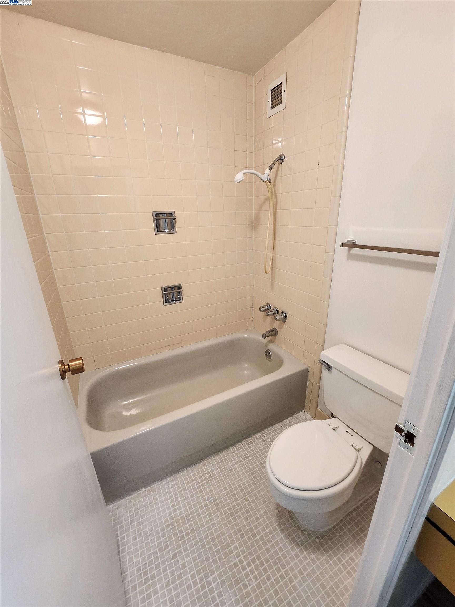 3909 Stevenson Boulevard, Unit 402 Fremont, CA 94538 - Photo 25 of 32 a bathroom with a toilet a sink and a bathtub