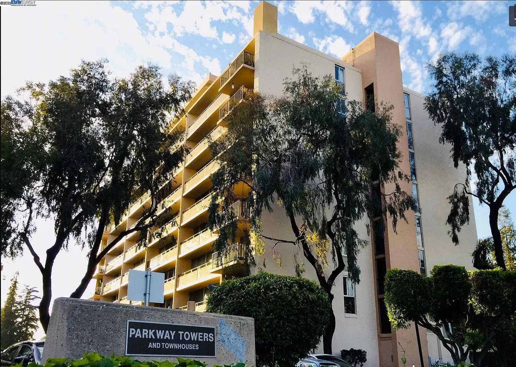 3909 Stevenson Boulevard, Unit 402 Fremont, CA 94538 - Photo 28 of 32 a view of a building with trees and stairs