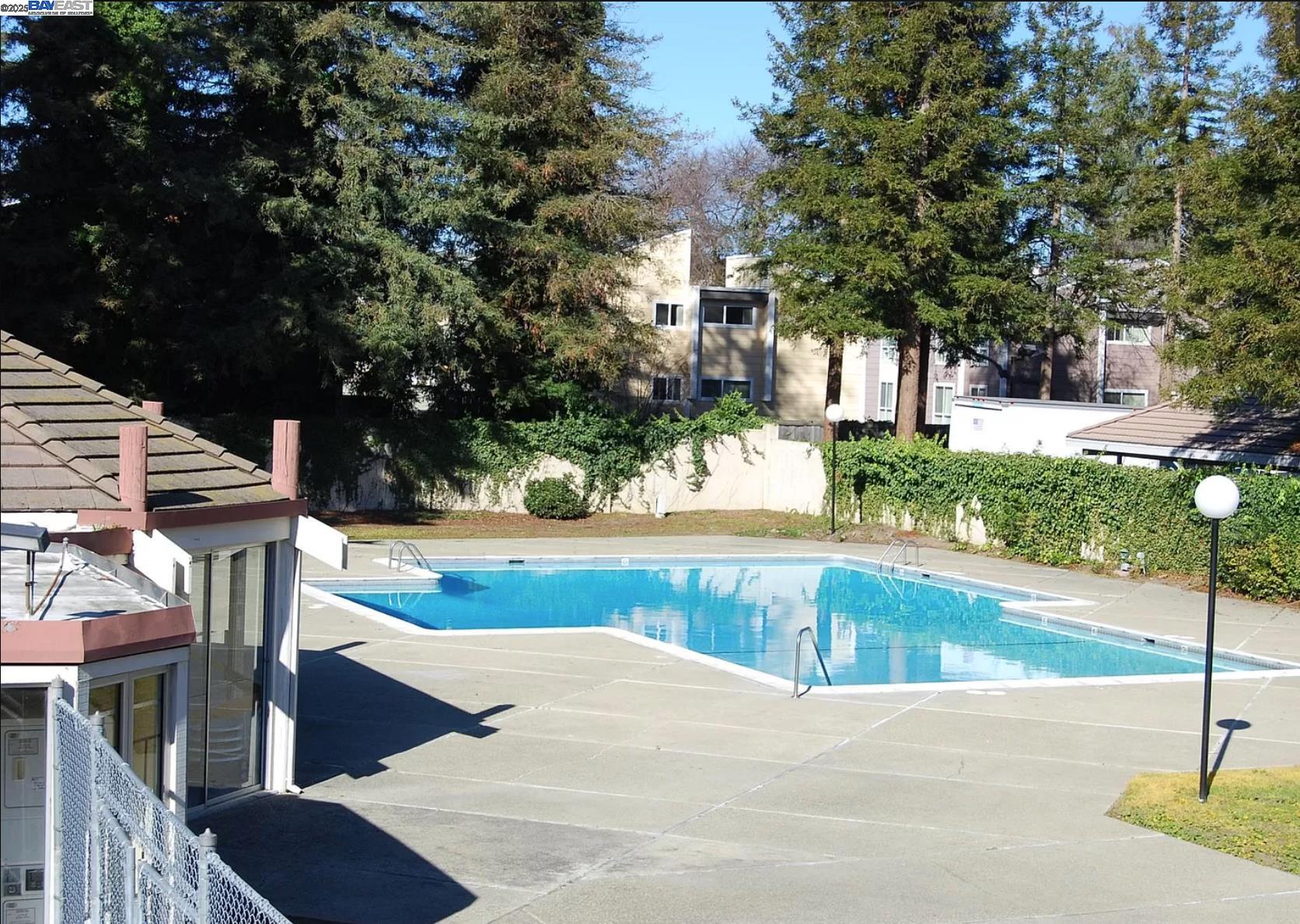 3909 Stevenson Boulevard, Unit 402 Fremont, CA 94538 - Photo 29 of 32 a view of a swimming pool with a patio