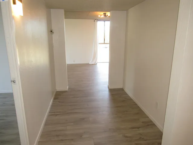 a view of a hallway with wooden floor