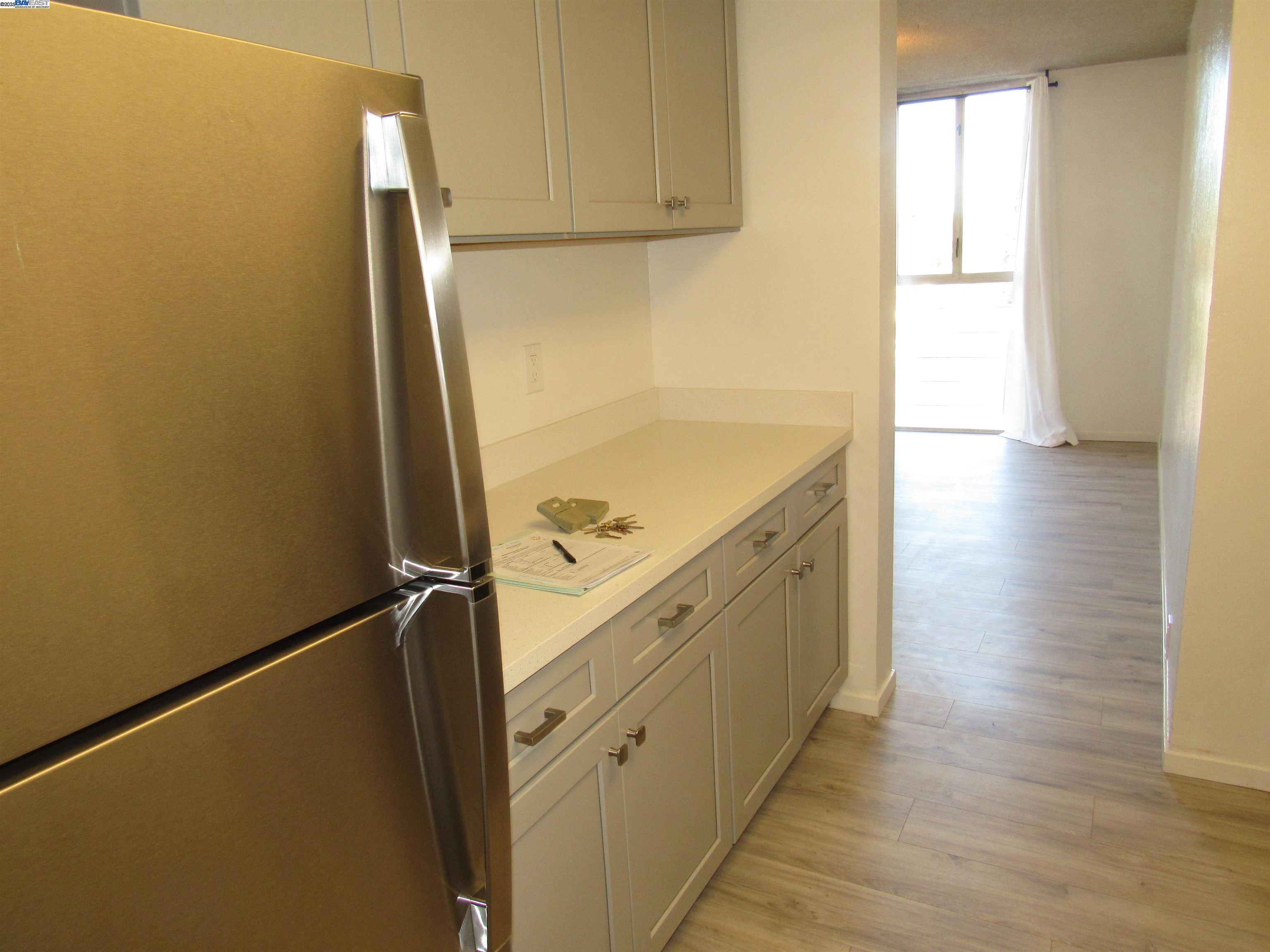 3909 Stevenson Boulevard, Unit 402 Fremont, CA 94538 - Photo 4 of 32 a view of a kitchen with a sink and dishwasher