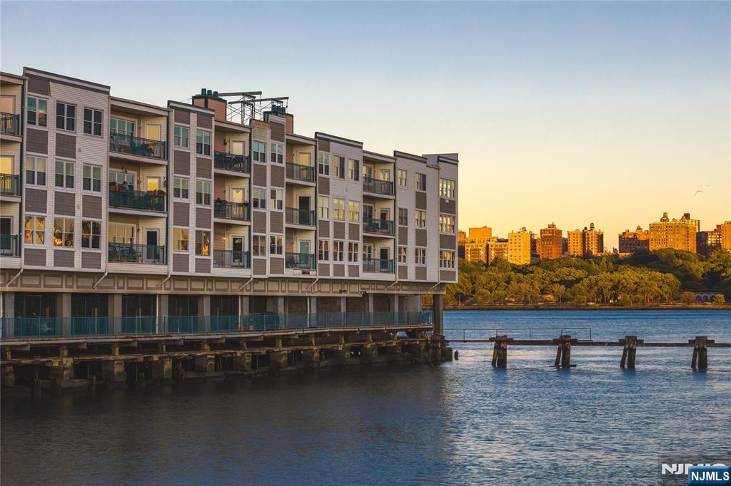 116 The Promenade, Unit 116 Edgewater, NJ 07020 - Photo 3 of 26 a view of a large building with a lake