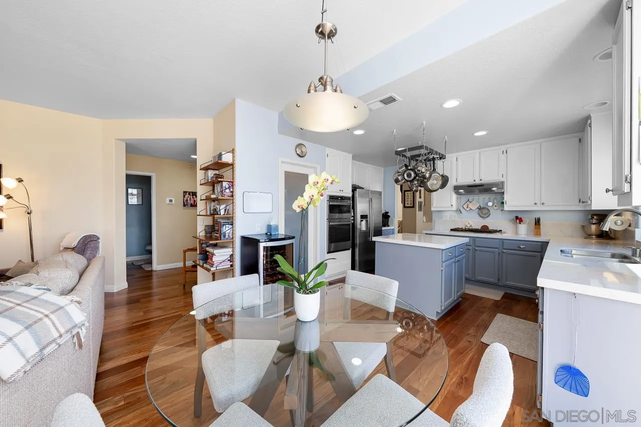 5114 Bella Collina Street Oceanside, CA 92056 - Photo 11 of 74 a living room with stainless steel appliances kitchen island granite countertop furniture and a kitchen view