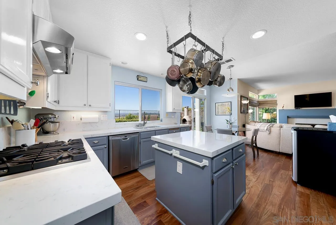 5114 Bella Collina Street Oceanside, CA 92056 - Photo 14 of 74 a kitchen with stainless steel appliances a stove a sink and a refrigerator