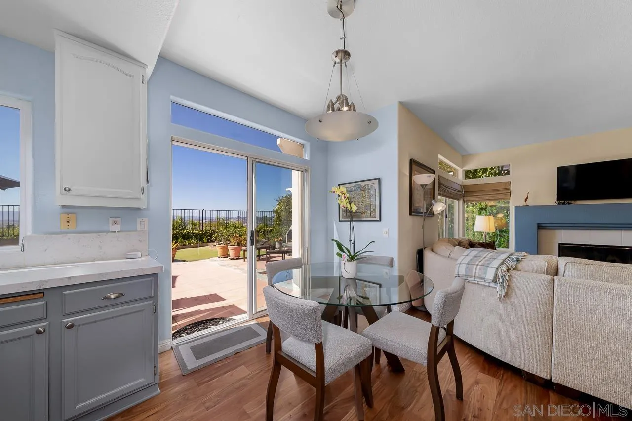 5114 Bella Collina Street Oceanside, CA 92056 - Photo 15 of 74 a view of a dining room with furniture window and wooden floor