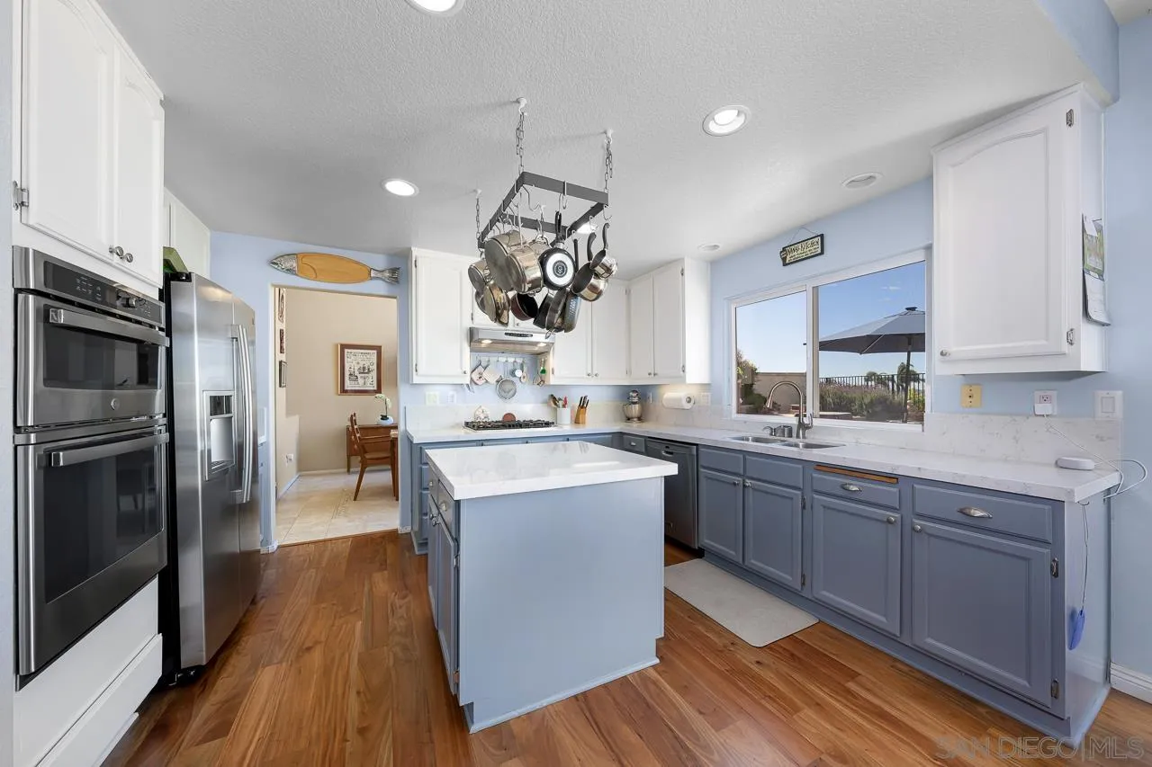 5114 Bella Collina Street Oceanside, CA 92056 - Photo 16 of 74 a kitchen with stainless steel appliances granite countertop a sink stove and refrigerator