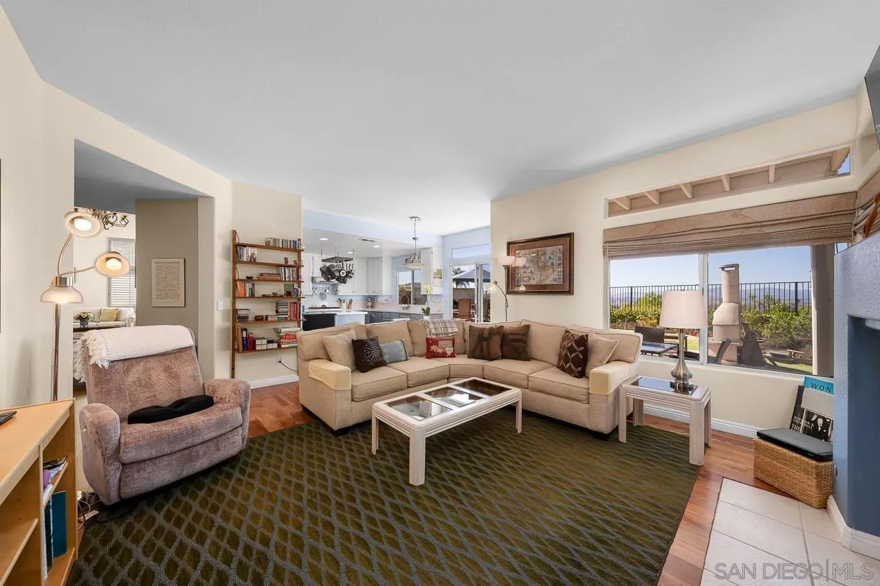 5114 Bella Collina Street Oceanside, CA 92056 - Photo 17 of 74 a living room with furniture wooden floor and a large window