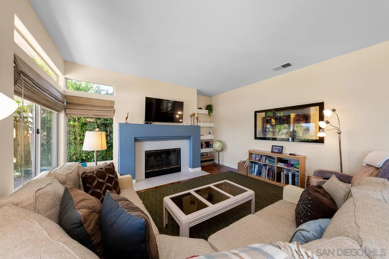 5114 Bella Collina Street Oceanside, CA 92056 - Photo 20 of 74 a living room with furniture and a fireplace