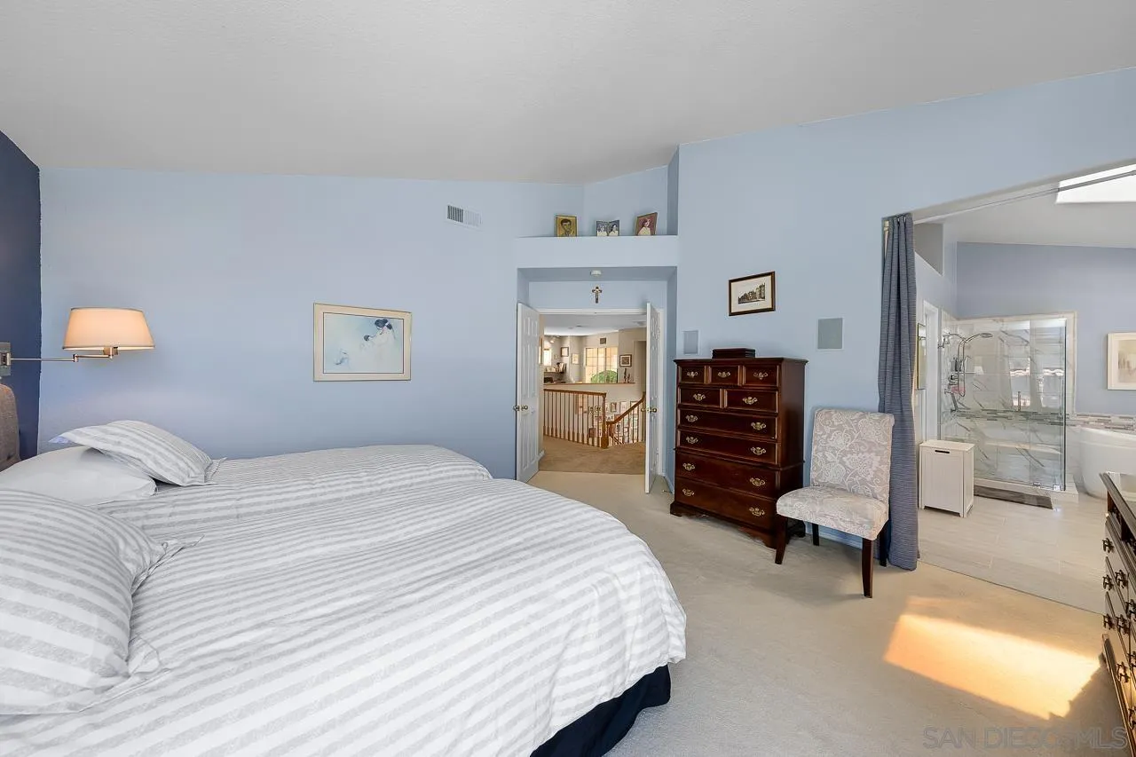 5114 Bella Collina Street Oceanside, CA 92056 - Photo 25 of 74 a bedroom with a bed and furniture