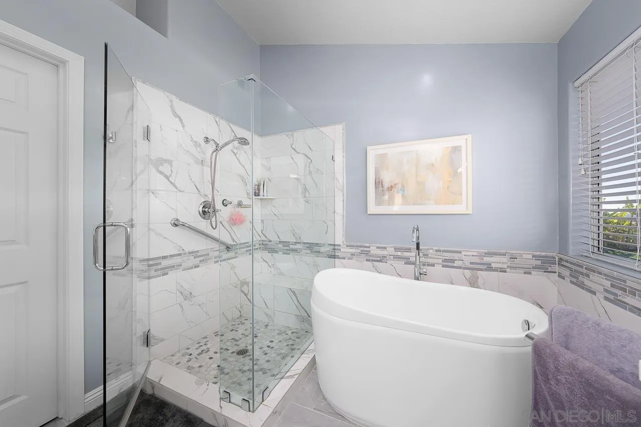 5114 Bella Collina Street Oceanside, CA 92056 - Photo 30 of 74 a bathroom with a granite countertop sink a toilet and shower