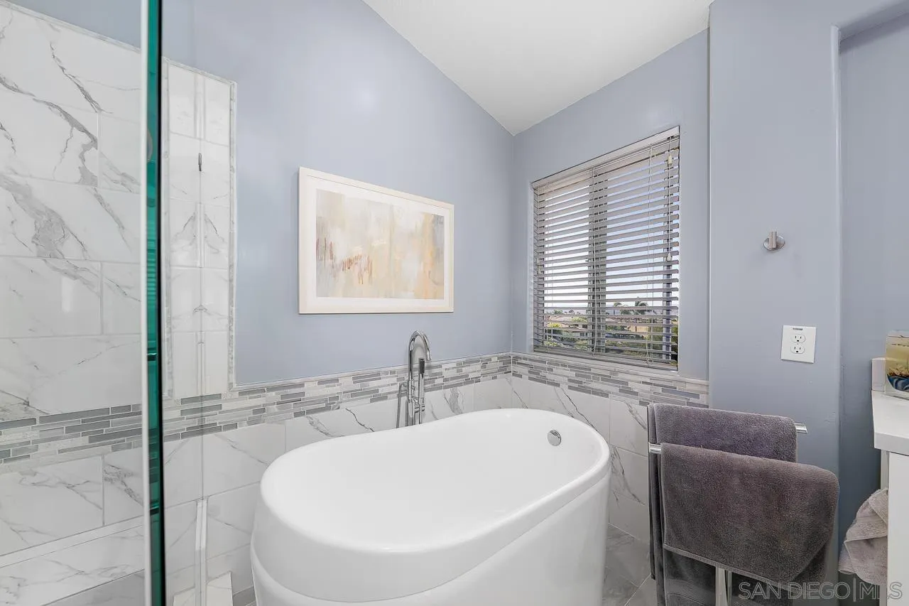 5114 Bella Collina Street Oceanside, CA 92056 - Photo 32 of 74 a bathroom with a sink and a bathtub