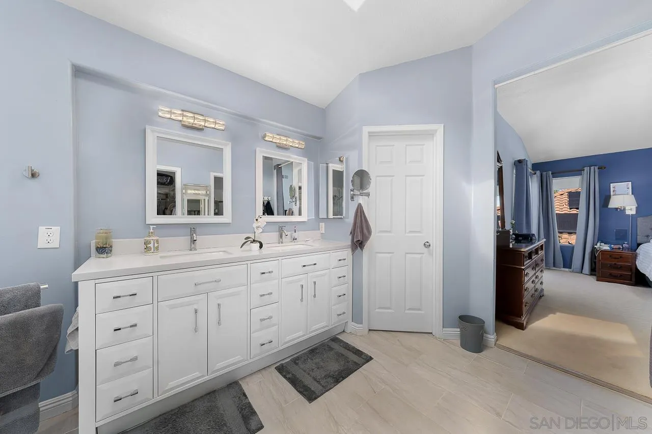 5114 Bella Collina Street Oceanside, CA 92056 - Photo 33 of 74 a spacious bathroom with a double vanity sink and mirror