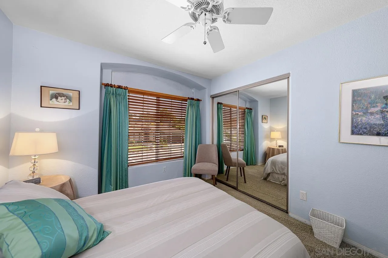 5114 Bella Collina Street Oceanside, CA 92056 - Photo 35 of 74 a bedroom with a bed and wooden floor