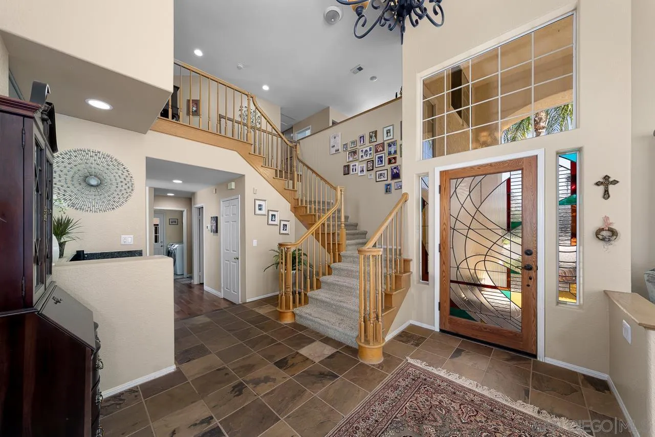 5114 Bella Collina Street Oceanside, CA 92056 - Photo 4 of 74 a view of entryway with furniture and wooden floor