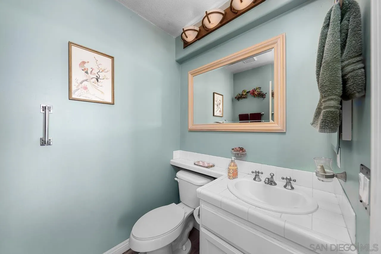 5114 Bella Collina Street Oceanside, CA 92056 - Photo 42 of 74 a bathroom with a toilet sink and mirror