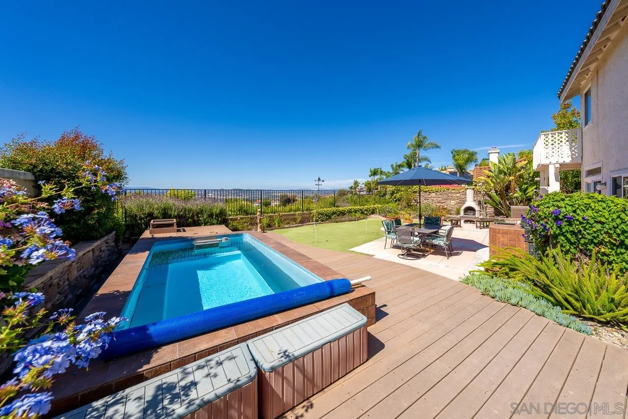 5114 Bella Collina Street Oceanside, CA 92056 - Photo 52 of 74 a view of a chairs and table on the wooden roof
