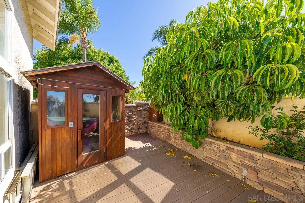 5114 Bella Collina Street Oceanside, CA 92056 - Photo 60 of 74 a view of a house with small yard plants and large tree