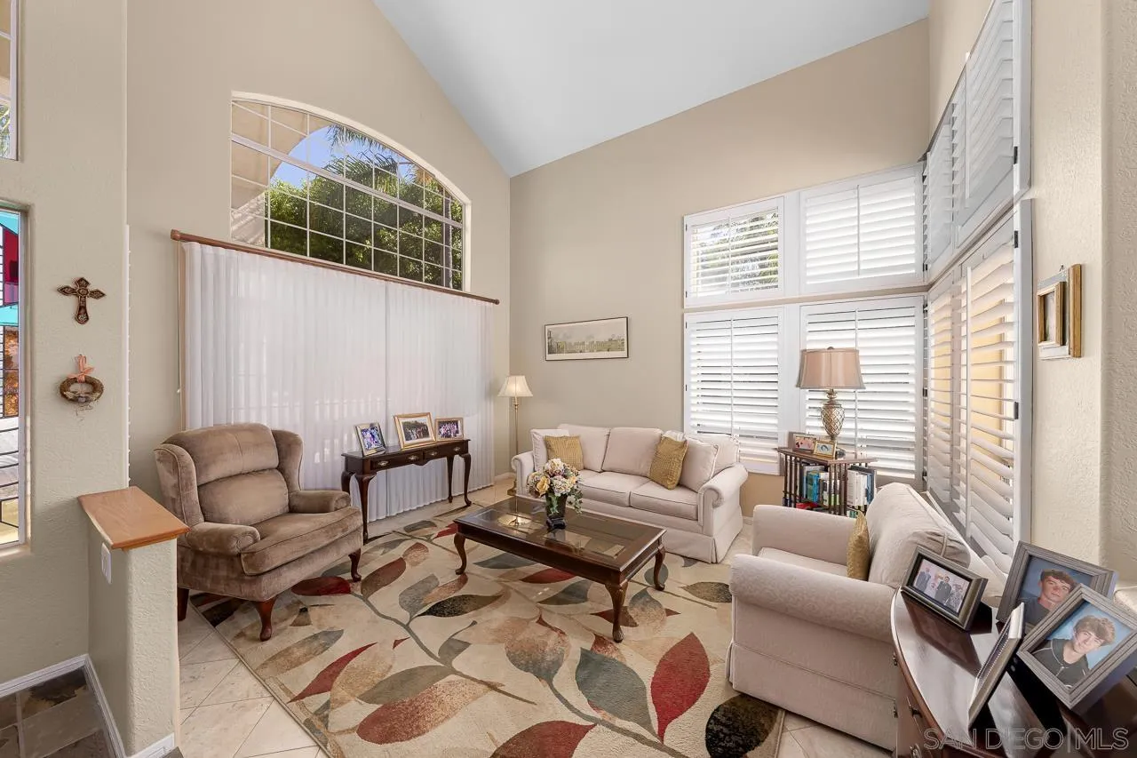 5114 Bella Collina Street Oceanside, CA 92056 - Photo 6 of 74 a living room with furniture and a large window