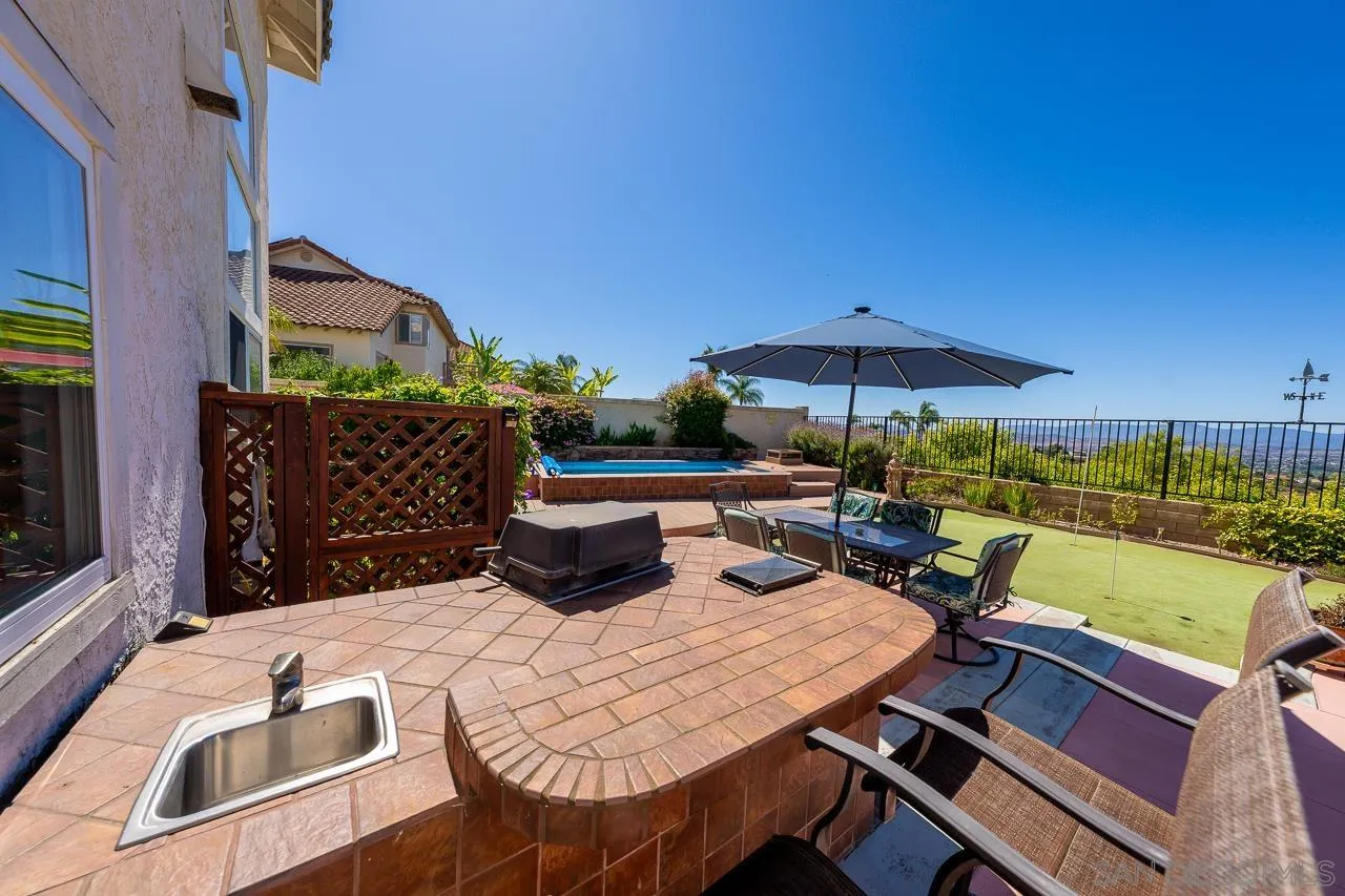 5114 Bella Collina Street Oceanside, CA 92056 - Photo 61 of 74 a view of an outdoor sitting area with furniture and umbrella