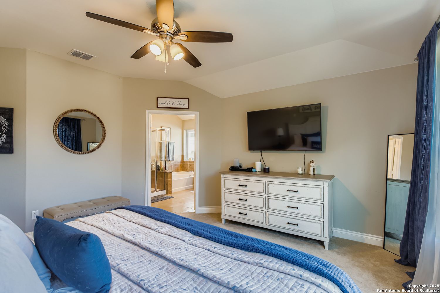 10639 Hibiscus Cove Helotes, TX 78023 - Photo 23 of 34 a bedroom with a bed and a flat tv screen on dresser