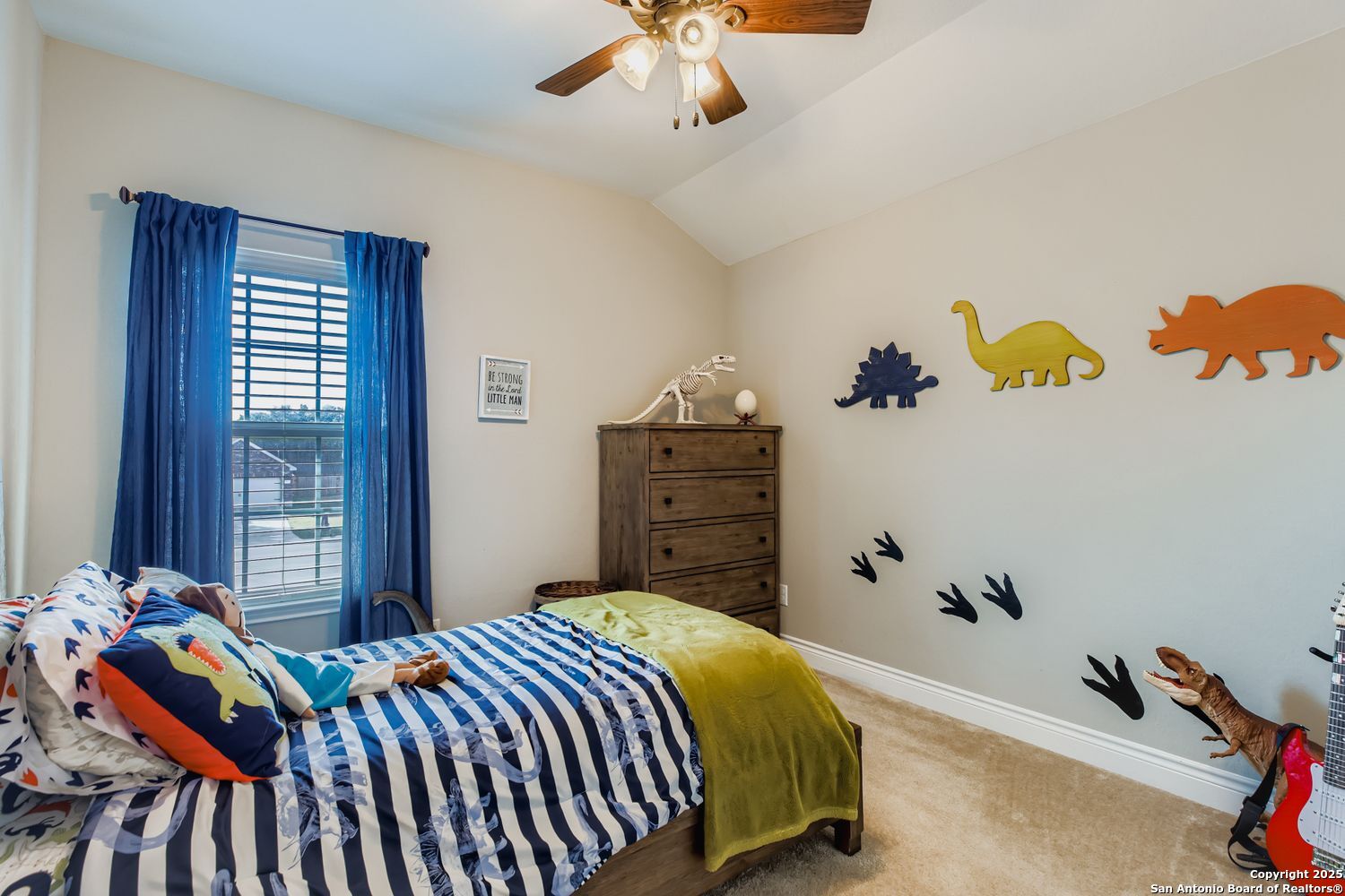 10639 Hibiscus Cove Helotes, TX 78023 - Photo 26 of 34 a bedroom with a bed and a chandelier