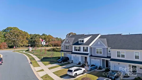a aerial view of a house with swimming pool and furniture