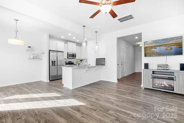 a view of a kitchen with a sink and a refrigerator