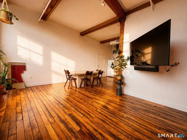 a view of a living room with furniture and a kitchen