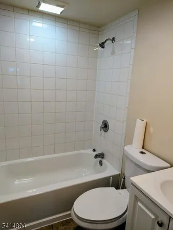 a toilet sitting next to a bath tub