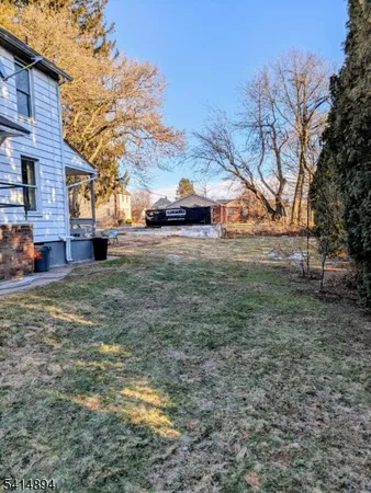 a view of a yard with a car parked in the road
