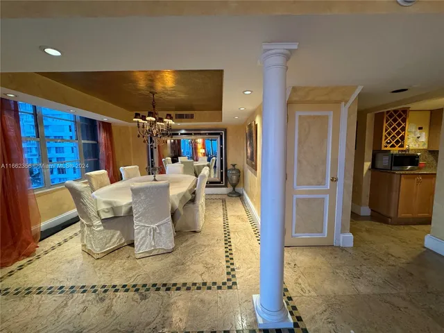 a kitchen with granite countertop a sink stainless steel appliances wooden floor and a counter top space