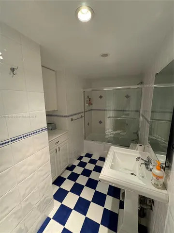 a bathroom with a sink a mirror and a bathtub