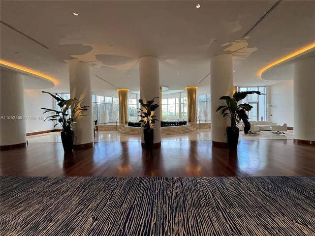 a palm tree sitting in front of a building