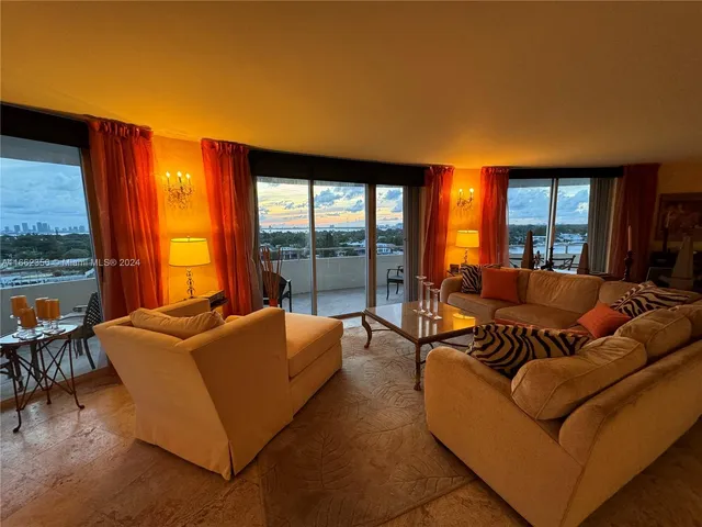 a living room with furniture and a floor to ceiling window