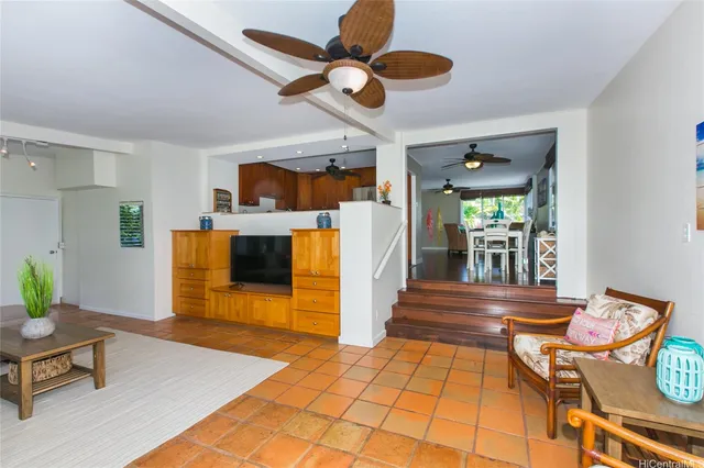 a view of a livingroom with furniture and a ceiling fan