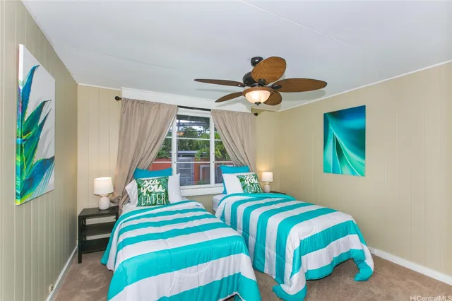 a bedroom with two beds and a large window