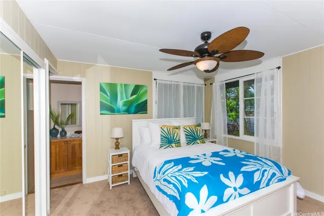 a bed sitting in a bedroom next to a window